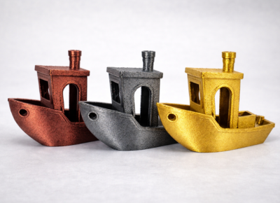 Three Benchy test boats printed in PETG-HS Metallic red, grey and gold