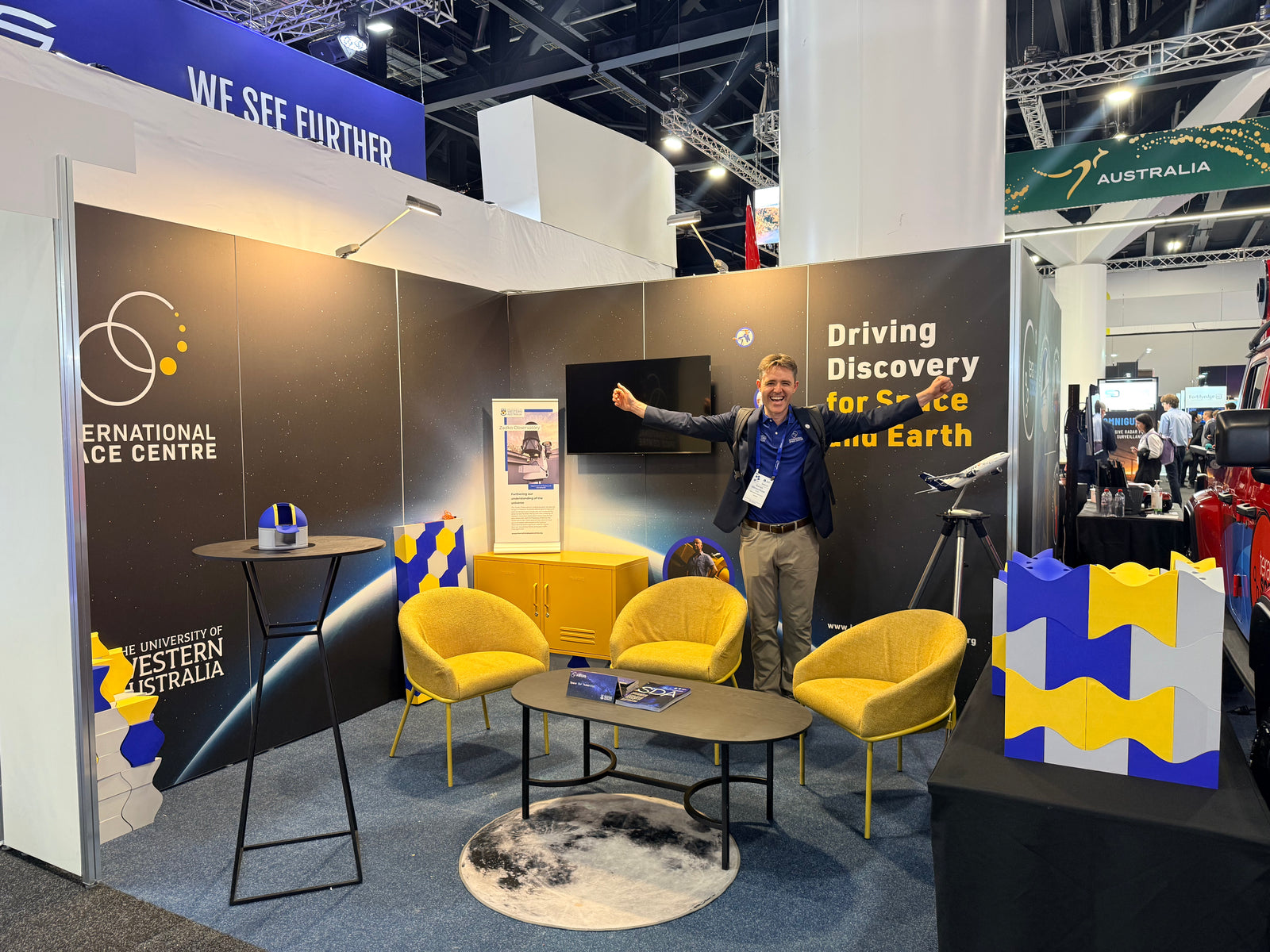Exhibition stand with a wall of blue and yellow Matte PLA hexagon tiles