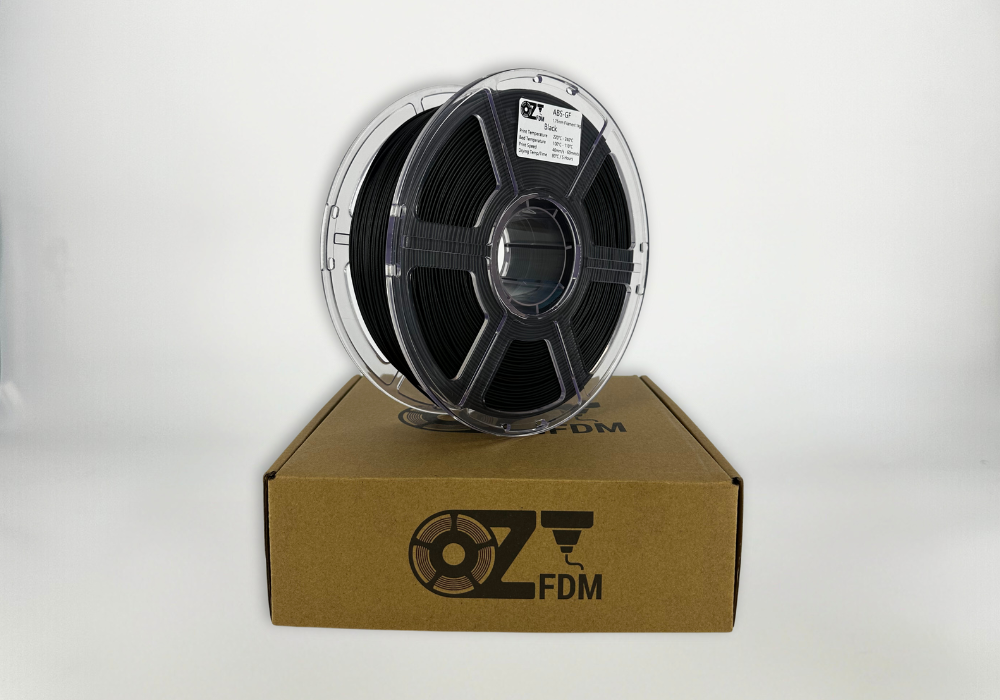 OzFDM ABS-GF spool in black on its shipping box