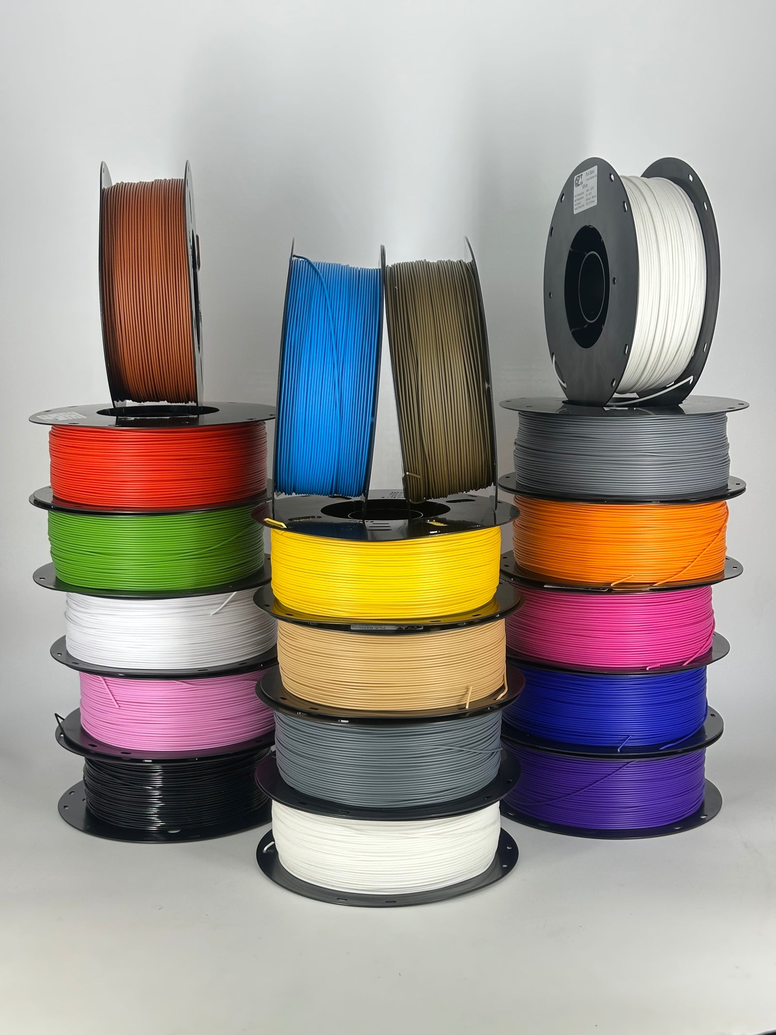 Stack of OzFDM PLA Basic spools in a range of colours