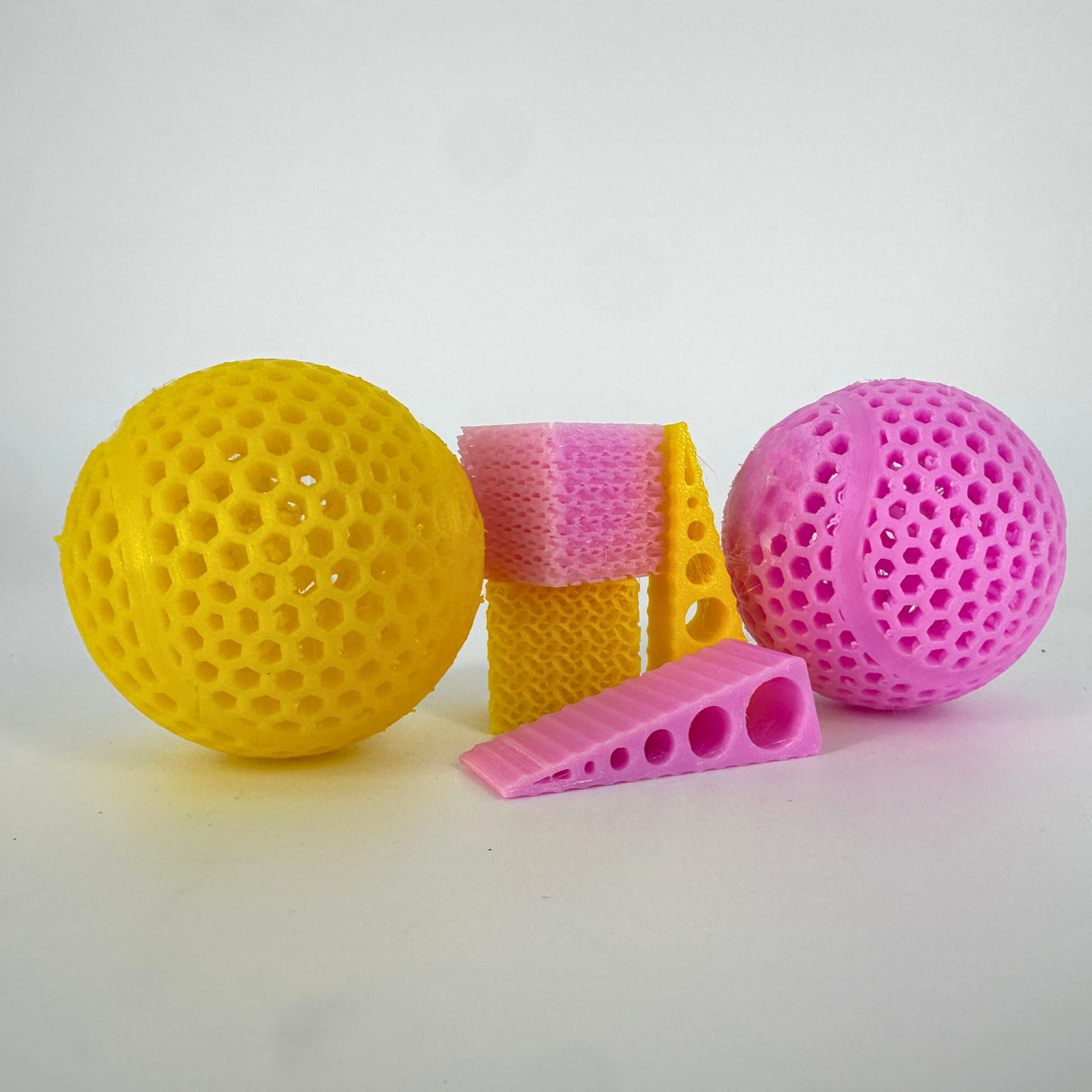 Tennis balls, door stops and infill blocks, TPU95A Yellow and Pink. 3D printed by Global3D