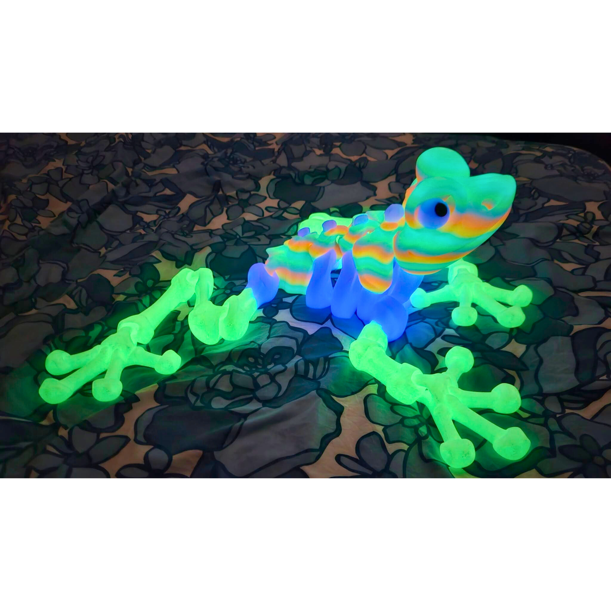 Articulated frog printed in PLA Glow in the Dark Rainbow by SeaMonkey Crafts, glowing in the dark