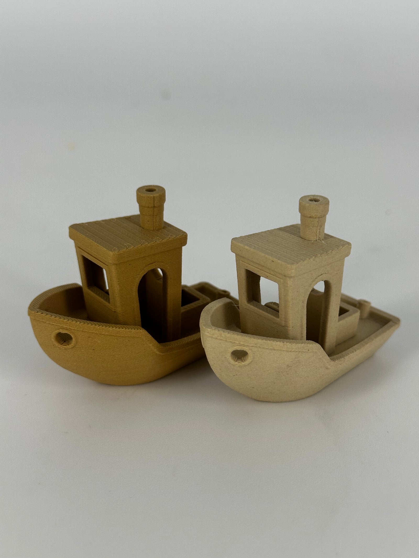 Two Benchy test boats printed in OzFDM PLA Wood