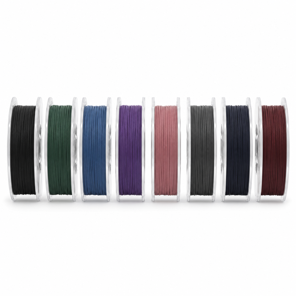 Row of OzFDM PLA-CF spools in black, green, blue, purple, pink, grey, midnight blue and marsala